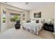 Serene main bedroom with a plush bed, neutral tones, and large windows for natural light at 26484 W Mohawk Ln, Buckeye, AZ 85396