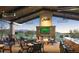 Relax in this stunning outdoor seating area with a fireplace and views of the golf course, a perfect spot for entertaining at 26484 W Mohawk Ln, Buckeye, AZ 85396