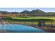 Enjoy the community pool with golf course views, mountains, and lush landscaping, creating a relaxing retreat at 26484 W Mohawk Ln, Buckeye, AZ 85396