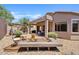 Expansive backyard showcasing a wooden deck, covered patio, and meticulously landscaped area, ideal for outdoor living at 3026 W Silver Fox Way, Phoenix, AZ 85045