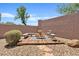 Charming backyard patio area with wooden deck, gravel, and seating, perfect for outdoor relaxation and entertaining at 3026 W Silver Fox Way, Phoenix, AZ 85045