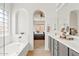 Bright bathroom with dual sinks, a soaking tub, and bedroom view at 3026 W Silver Fox Way, Phoenix, AZ 85045