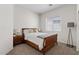 Cozy bedroom with dark-wood furniture, neutral walls, and soft carpeting at 3026 W Silver Fox Way, Phoenix, AZ 85045