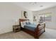Cozy bedroom features a wood sleigh bed, soft carpeting, and sunlit windows at 3026 W Silver Fox Way, Phoenix, AZ 85045