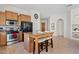 Functional kitchen showcases an island with bar seating and stainless steel appliances at 3026 W Silver Fox Way, Phoenix, AZ 85045