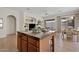 An open concept kitchen showcases an island that includes cabinets and bar stool seating at 3026 W Silver Fox Way, Phoenix, AZ 85045