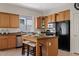Efficient kitchen includes an island with bar stool seating, stainless steel appliances, and ample cabinetry at 3026 W Silver Fox Way, Phoenix, AZ 85045
