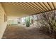 Exterior view of a covered carport area with gravel and cacti around the border at 3239 E Kings Ave, Phoenix, AZ 85032