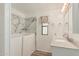 Bright bathroom with a walk-in tub and a marble countertop vanity and matching shower at 3239 E Kings Ave, Phoenix, AZ 85032