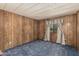 Standard bedroom showcasing carpeted floors and wood paneled walls with a window at 3239 E Kings Ave, Phoenix, AZ 85032