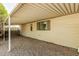 Covered carport area with gravel and view of the exterior wall of the residence at 3239 E Kings Ave, Phoenix, AZ 85032