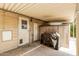 Exterior view of a carport with concrete flooring, an uncovered grill, and exterior entrance at 3239 E Kings Ave, Phoenix, AZ 85032