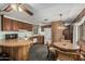 Well-lit kitchen with white appliances, ample wooden cabinetry, a breakfast bar, and a dining area at 3239 E Kings Ave, Phoenix, AZ 85032