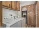 Features a washer and dryer combo in a wood paneled laundry space at 3239 E Kings Ave, Phoenix, AZ 85032