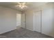 Neutral bedroom with grey carpet, white walls, ceiling fan, and double door closet at 3282 S Warner Dr, Apache Junction, AZ 85120