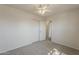 Neutral bedroom with carpet, white walls, a ceiling fan, and sliding-door closet at 3282 S Warner Dr, Apache Junction, AZ 85120