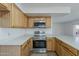 Efficient kitchen featuring updated stainless steel appliances and oak cabinetry at 3282 S Warner Dr, Apache Junction, AZ 85120