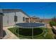 Backyard featuring a trampoline and an outdoor kitchen, perfect for entertaining at 3715 S 57Th Ln, Phoenix, AZ 85043