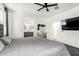 Bright bedroom with a vanity, views to bathroom, and a ceiling fan at 3715 S 57Th Ln, Phoenix, AZ 85043