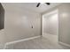 Bright bedroom features a ceiling fan, light walls, gray accents and a large window for ample natural light at 3715 S 57Th Ln, Phoenix, AZ 85043