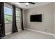 Bright bedroom features a ceiling fan, light walls, gray accents and a large window for ample natural light at 3715 S 57Th Ln, Phoenix, AZ 85043