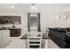 Dining area with wood table set, next to kitchen and large sectional sofa at 3715 S 57Th Ln, Phoenix, AZ 85043