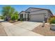 Charming single-story home featuring a two-car garage, neutral stucco, desert landscaping, and a welcoming front door at 3715 S 57Th Ln, Phoenix, AZ 85043