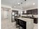 Bright kitchen featuring stainless steel appliances, an island with seating, and ample cabinet space at 3715 S 57Th Ln, Phoenix, AZ 85043