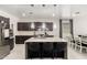 Kitchen with granite island, seating, pendant lights, and dark colored cabinets at 3715 S 57Th Ln, Phoenix, AZ 85043