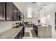 Spacious kitchen with dark cabinetry, stainless steel appliances, and granite countertops at 3715 S 57Th Ln, Phoenix, AZ 85043