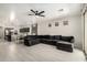 Bright living room open to the kitchen, featuring tile floors and a large sectional at 3715 S 57Th Ln, Phoenix, AZ 85043