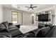 Comfortable living room featuring a large entertainment center and tile floors at 3715 S 57Th Ln, Phoenix, AZ 85043