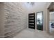 Grand entry foyer with a stacked stone accent wall and a modern front door at 37200 N Cave Creek Rd # 1045, Scottsdale, AZ 85262