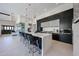 Modern kitchen featuring waterfall island, sleek black cabinetry, and bar stool seating at 37200 N Cave Creek Rd # 1045, Scottsdale, AZ 85262