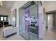 Wine room featuring glass enclosure and custom shelving at 37200 N Cave Creek Rd # 1045, Scottsdale, AZ 85262