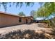 Large backyard with a covered porch, gravel landscaping, and a privacy fence, perfect for outdoor living at 3722 W Hadley St, Phoenix, AZ 85009