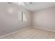Bedroom with neutral walls, window, and tiled floors at 3722 W Hadley St, Phoenix, AZ 85009