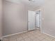 A bedroom with tile flooring and a neutral wall color. Closet door access at 3722 W Hadley St, Phoenix, AZ 85009