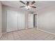 Bright bedroom with a ceiling fan, tiled floor and closet space at 3722 W Hadley St, Phoenix, AZ 85009