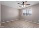 A bedroom with tile flooring, a ceiling fan, and a window at 3722 W Hadley St, Phoenix, AZ 85009