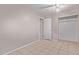 A bright bedroom with a closet and tile flooring at 3722 W Hadley St, Phoenix, AZ 85009