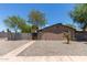 Charming home featuring gravel landscaping, a secure fence, and mature trees providing curb appeal at 3722 W Hadley St, Phoenix, AZ 85009