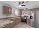 An eat-in kitchen featuring stainless steel appliances, tile counters, and warm cabinets at 3722 W Hadley St, Phoenix, AZ 85009