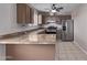 An eat-in kitchen featuring stainless steel appliances, tile counters, and warm cabinets at 3722 W Hadley St, Phoenix, AZ 85009