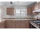 An eat-in kitchen featuring tile counters and warm cabinets at 3722 W Hadley St, Phoenix, AZ 85009