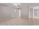 A neutral living space with tile flooring, a ceiling fan, and two entry doors at 3722 W Hadley St, Phoenix, AZ 85009