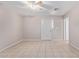 A neutral living space with tile flooring, a ceiling fan, and an entry door at 3722 W Hadley St, Phoenix, AZ 85009