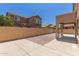 Large backyard with a desert landscape, tall wall, and patio pavers perfect for entertainment at 4051 E Torrey Pines E Ln, Chandler, AZ 85249