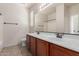 Bright bathroom with double sinks, wood cabinets, and tile flooring for comfortable living at 4051 E Torrey Pines E Ln, Chandler, AZ 85249