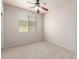 Carpeted bedroom featuring a view via a window with blinds and a ceiling fan for comfortable living at 4051 E Torrey Pines E Ln, Chandler, AZ 85249